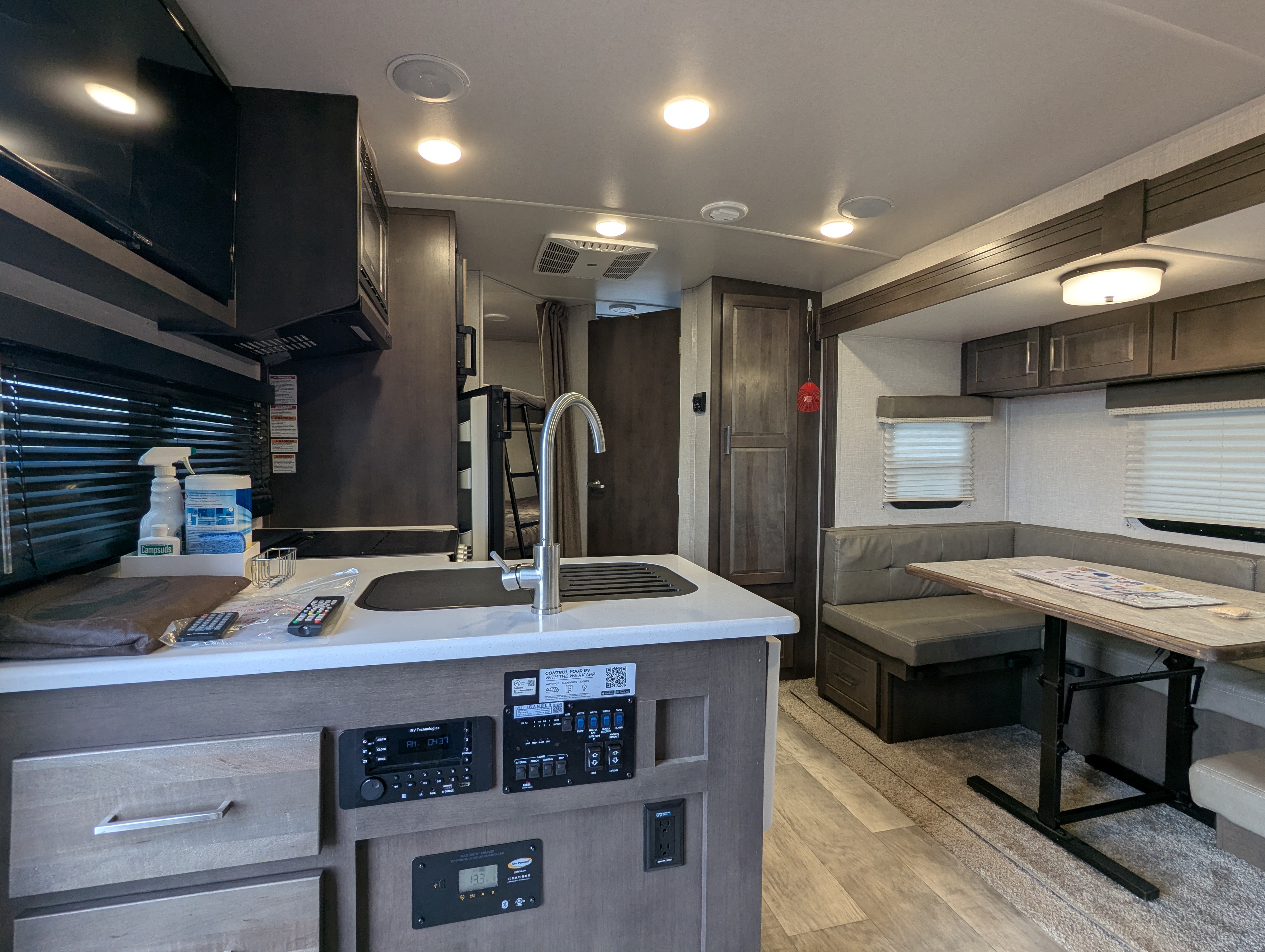 Kitchen island with sink, control panel, and dinette