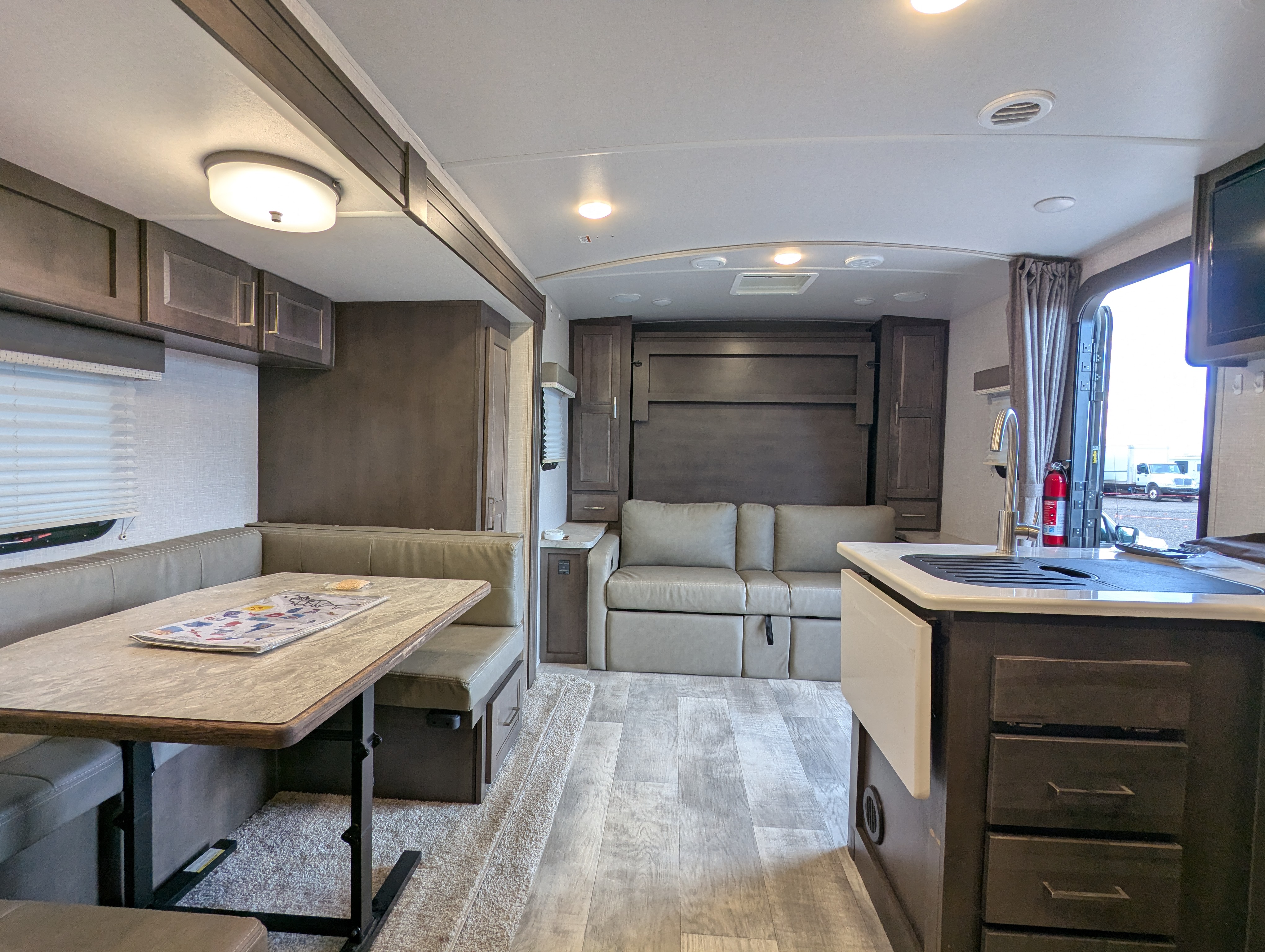 Full interior view — dinette, theater seating, and kitchen