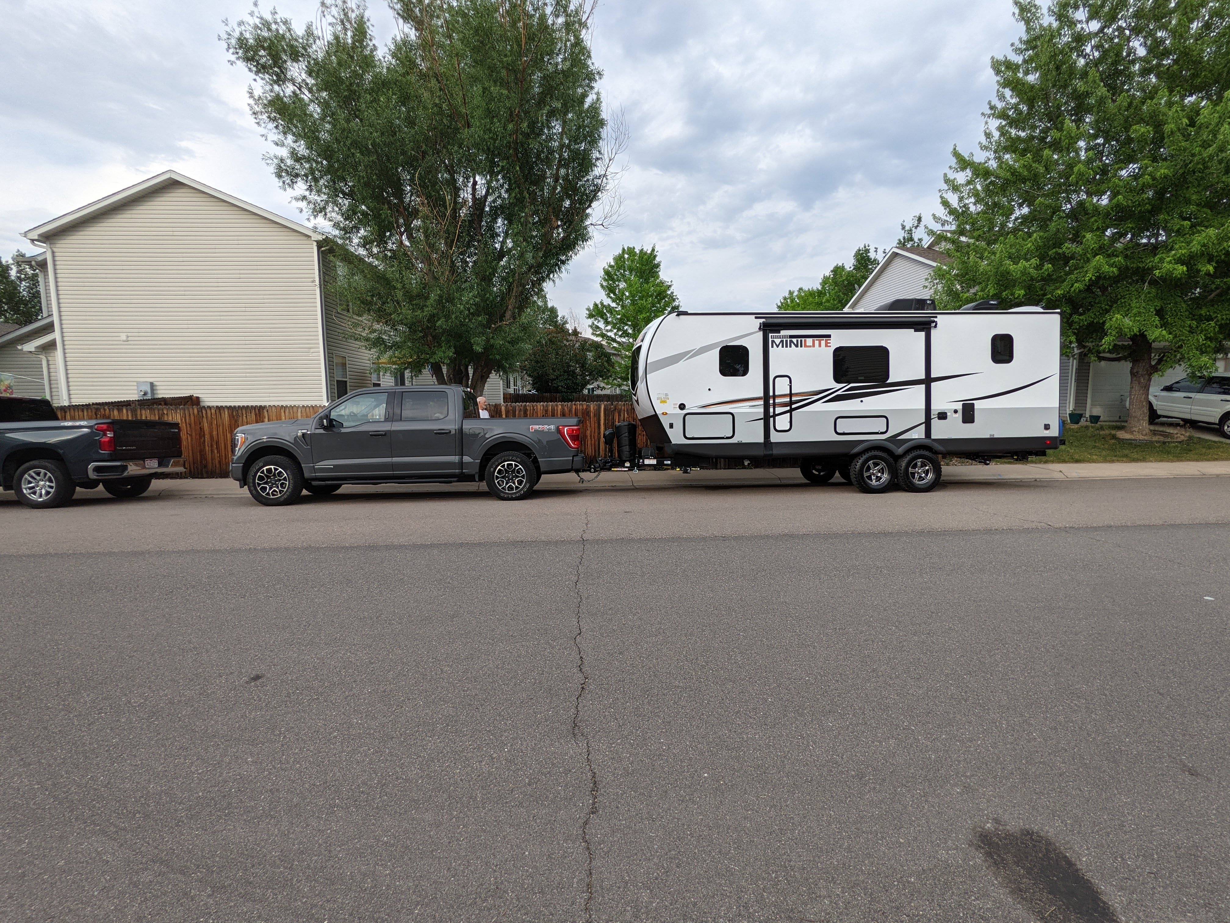 Camper hitched to truck in the driveway