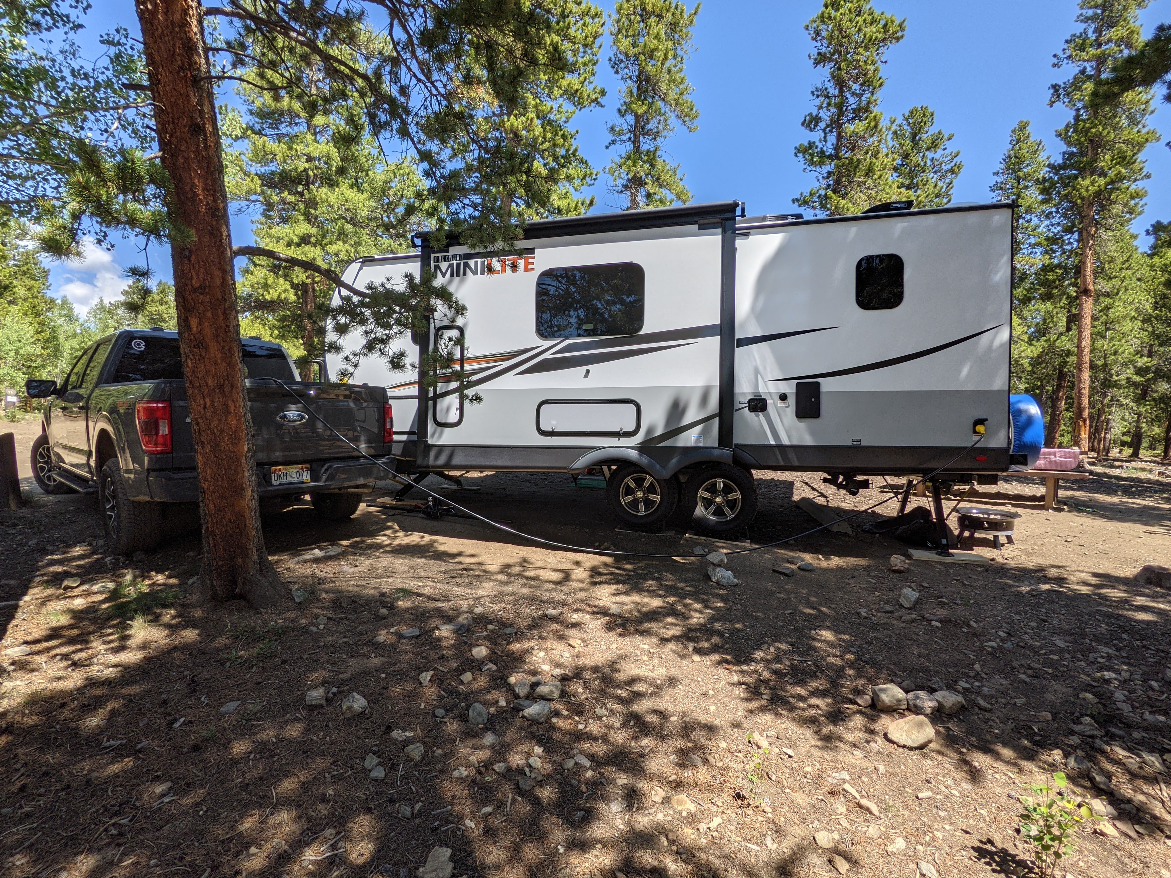 Camper among pine trees in the mountains