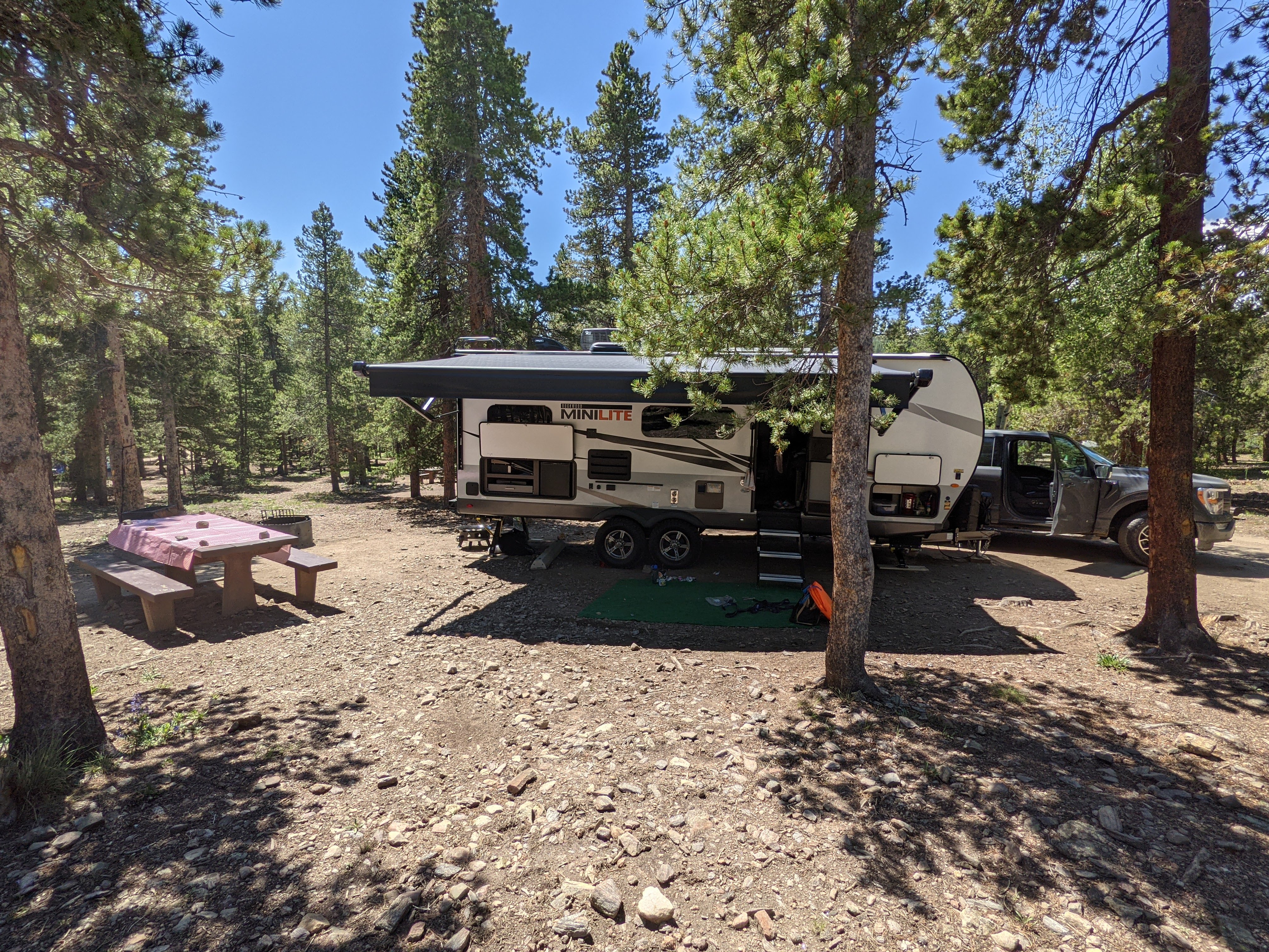 Camper at mountain campsite with picnic table